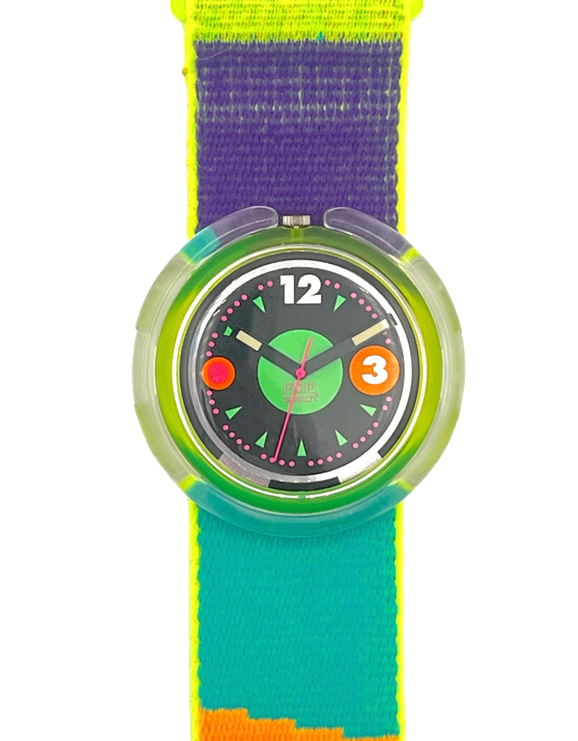 A colorful wristwatch with a bright striped fabric strap in neon yellow, purple, teal, and orange, featuring a translucent green bezel and a black watch face with white numerals.