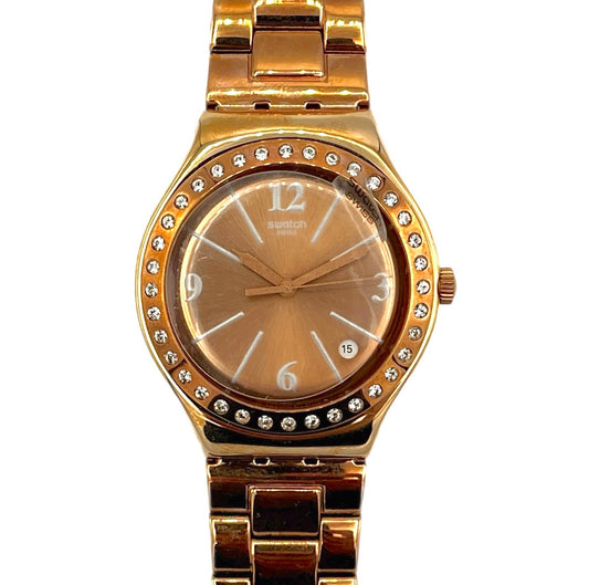 Gold watch with diamond-studded bezel on a white background