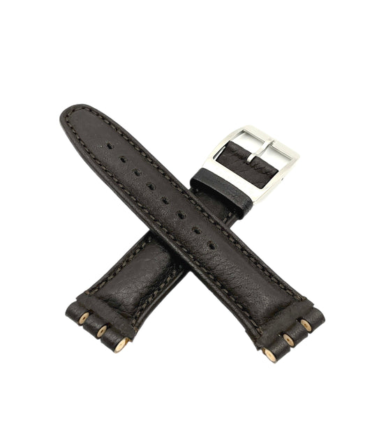 Brown leather watch strap with silver buckle on a white background
