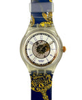 Swatch watch with blue and gold strap on a white background