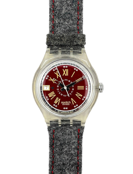 Wristwatch with red face and gray textured strap on white background