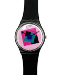 A wrist watch with a black strap and a round silver-tone case, featuring a colorful geometric dial with pink, blue, and black shapes on a light background.