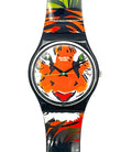 A Swatch wristwatch featuring a colorful tiger face design on the dial and a matching tropical print strap with orange, black, green, and white patterns, shown against a plain white background.