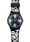 A Swatch wristwatch with a black case and a black strap decorated with a repeating pattern of white skulls with colorful eyes and teeth, set against a plain white background.