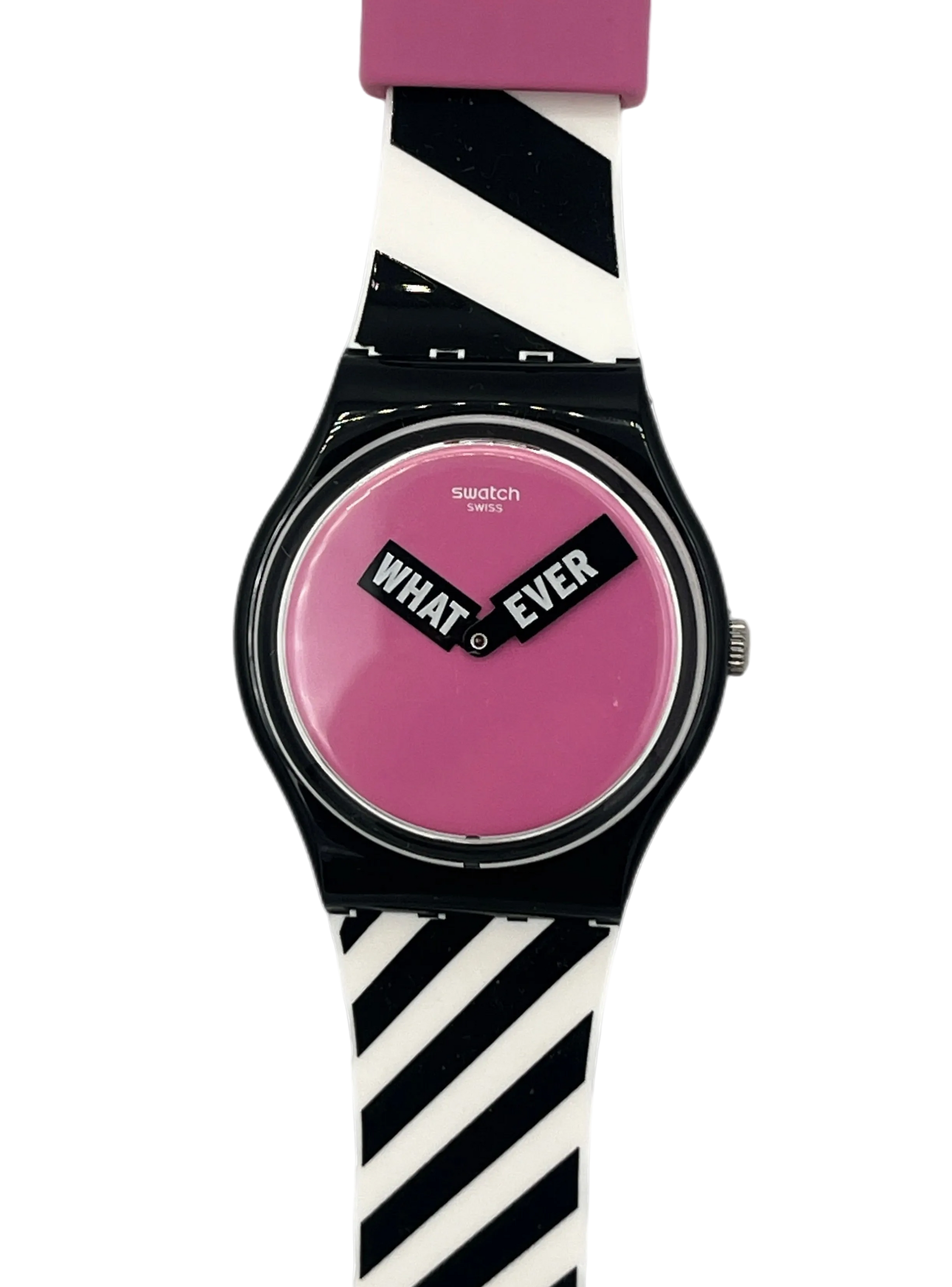 Swatch wristwatch with a black case, pink dial, and a black-and-white striped silicone strap, featuring the words 'WHAT EVER' on the dial.