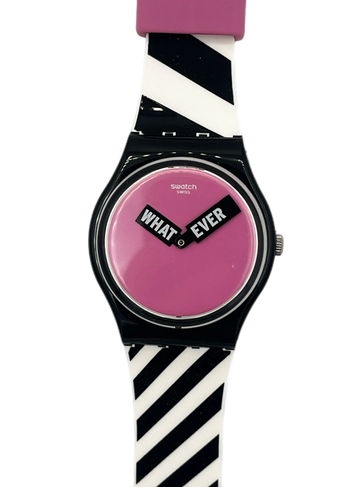 Swatch wristwatch with a black case, pink dial, and a black-and-white striped silicone strap, featuring the words 'WHAT EVER' on the dial.