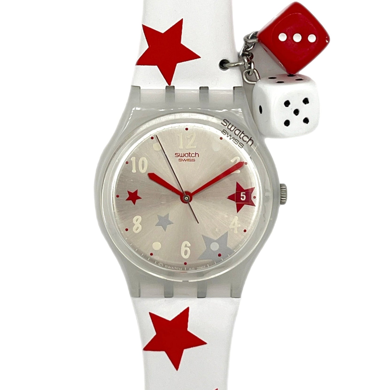 Swatch watch with red star pattern on strap and dice charm on white background