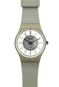 A Swatch wristwatch with a light gray silicone strap, a beige-toned case, and a white dial featuring blue hands and a gray inner ring.