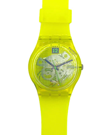Swatch wrist watch with a translucent neon yellow-green case and matching silicone strap, featuring a patterned dial and a 12-hour display window.