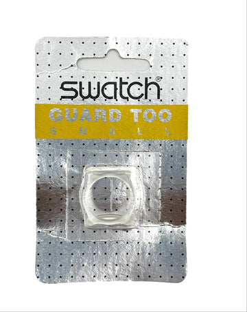 A Swatch Guard Too Small clear silicone ring accessory in its original silver blister card packaging with a yellow band.