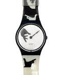 Swatch wristwatch with a glossy black and white handprint patterned strap and a white dial featuring a gray hand graphic.
