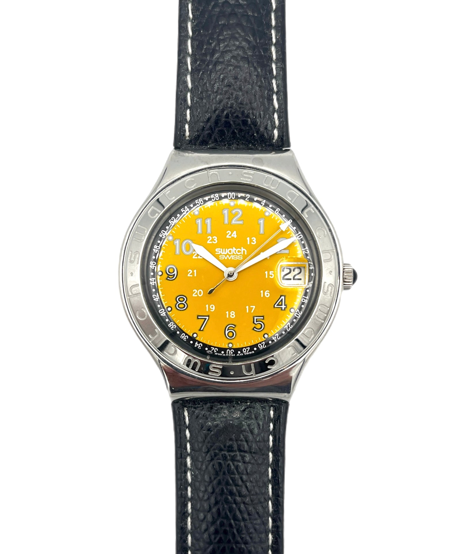 Watch with yellow face and black strap on white background