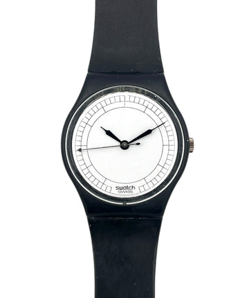 A Swatch wristwatch with a black silicone strap, black case, and a minimalist white dial with black hands.