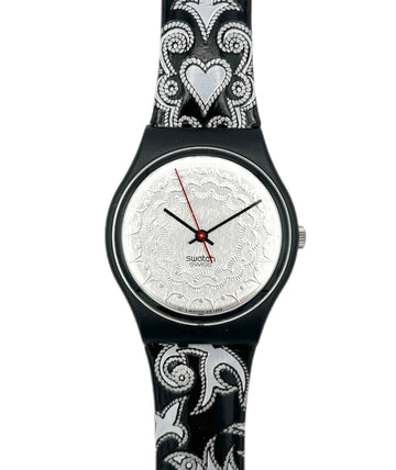 Swatch watch with black and white patterned strap on a white background