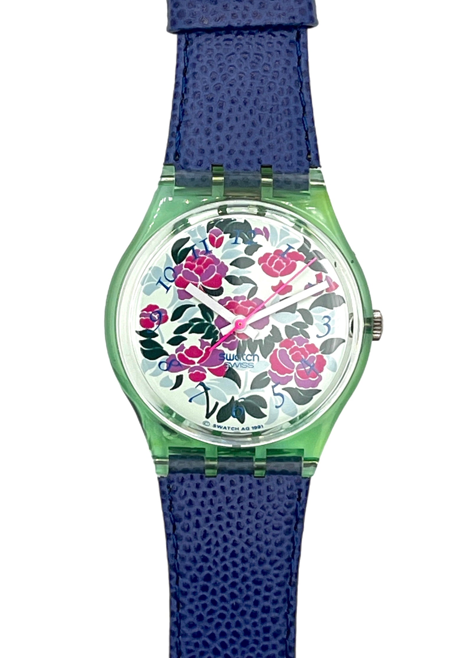 A Swatch watch featuring a textured blue strap, a translucent green case, and a white dial decorated with a vibrant pink and red floral pattern.