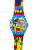 Swatch wristwatch with a bright blue case and a colorful abstract puzzle-piece strap featuring red, yellow, green, and purple shapes on a white background.