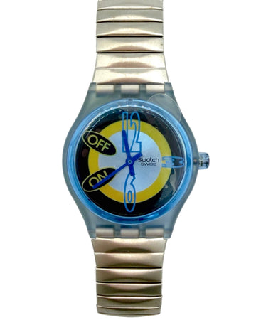 A Swatch digital watch with a translucent light blue case and a metallic silver link bracelet, featuring a colorful dial with blue hands, yellow and black accents, and 'swatch' printed on the face.