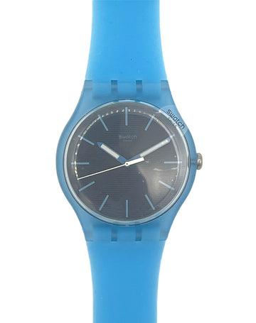 Swatch analog watch with a translucent light blue silicone strap and a dark gray textured dial, shown against a plain white background.