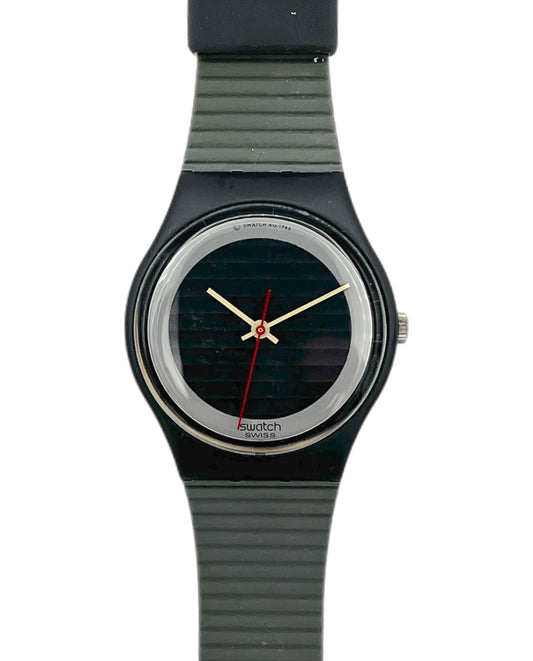 Swatch watch with black strap and black dial on a white background