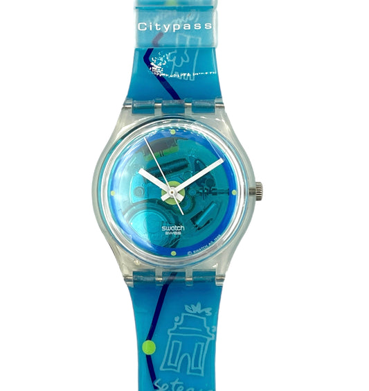 Swatch watch with blue strap and transparent case on a white background