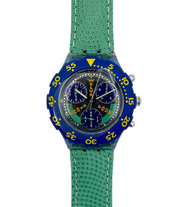 Wristwatch with blue case and green strap on a white background
