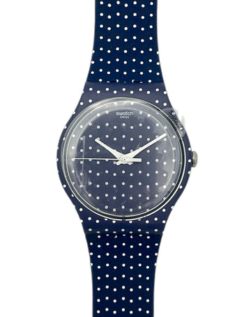 Swatch watch with navy blue polka dot strap on a white background