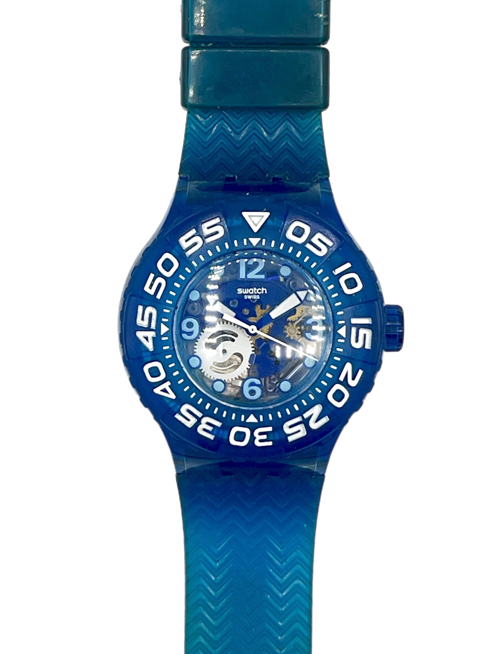 A Swatch wristwatch featuring a translucent blue silicone strap and bezel, a blue dial with white numerals, and a visible mechanical movement through the transparent case.