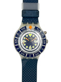 Swatch Swatch Speedo watch with a textured blue strap, blue dial, and blue bezel with white numerals and orange accents.