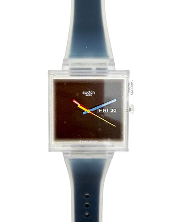 Swatch square analog watch with a translucent dark blue silicone strap and a clear plastic case housing a dark brown dial with colorful hands.
