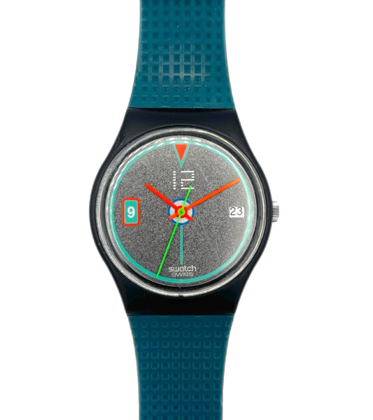 Swatch Swatch Classic wrist watch with a textured teal blue strap, black case, and a speckled gray dial with orange and green hands.