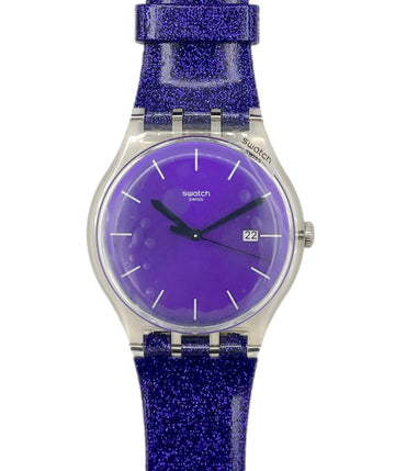 Swatch watch with purple glitter strap and face on a white background
