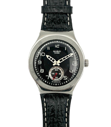 Swatch watch with black strap and black dial on a white background