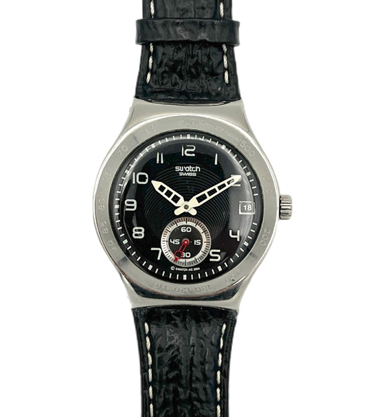Swatch watch with black strap and black dial on a white background
