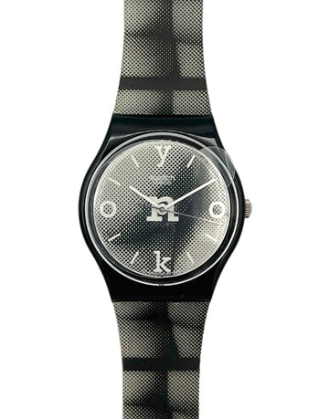 Wristwatch with black and gray checkered strap on a white background