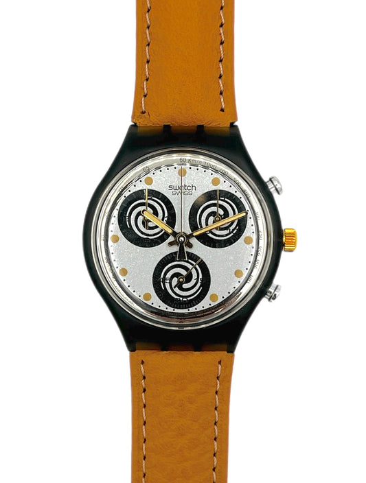 Swatch watch with brown strap and black and white face on a white background
