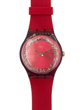 A Swizzlin' Swatch wristwatch featuring a vibrant red silicone strap, a red dial encrusted with clear rhinestones, and gold-tone hands.
