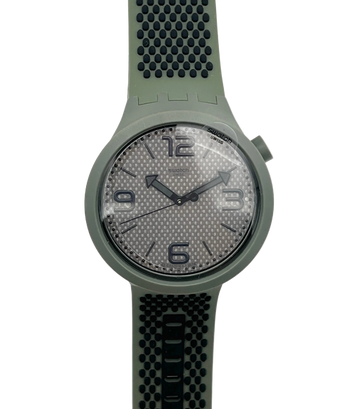 A Swatch wristwatch featuring an olive green silicone strap and case, with a textured gray dial and black numerals.